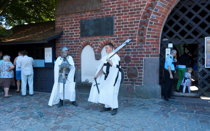 12 - Costumed reenactors portraying Teutonic Knights outside the brick gate of Malbork Castle in Poland